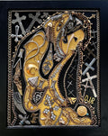 An intricate mixed-media religious artwork featuring a golden and silver-tone horned figure, draped with chains and surrounded by crosses, beads, and ornate metallic details on a black background.